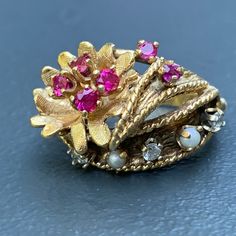 We take pride in finding unique , quality ~ Antique /Vintage jewelry pieces which are carefully hand picked by us so that you can add them to your treasure/ collection or gift to someone you love ~ We try to add plenty of items every week and have been selling online for more then 10 years . Vintage ~ 14kt yellow gold ~ Diamond ~ rubies ~ seed pearl ~ Cocktail /dinner ring ~ There are 6 small prong set faceted rubies , 3 diamonds and two seed pearls with applied wire work ~ Very well made ring . Heirloom Multi-stone Pearl Ring Gift, Heirloom Multi-stone Pearl Ring As Gift, Antique 14k Gold Pearl Ring For Anniversary, Vintage 14k Gold Pearl Wedding Ring, Vintage Gold Hallmarked Pearl Ring, Vintage Pearl Ring With Gemstone, Vintage 14k Gold Pearl Ring, Victorian 14k Gold Pearl Ring Gift, Victorian Style 14k Gold Pearl Ring For Anniversary