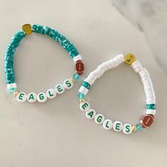 two beaded bracelets with the word eagles on them