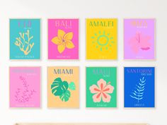 six colorful posters with different types of flowers and plants on the wall above a crib