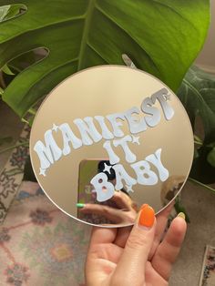 a person holding up a mirror with the words mandiest it baby on it