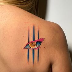 a woman with a tattoo on her back has an eye in the center of it