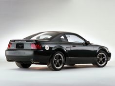 a black sports car parked in front of a white background