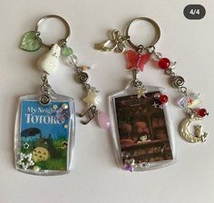 two key chains with pictures and charms attached to them