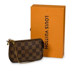 The Pochette is a petite accessory perfect to add to your Louis Vuitton day bag or simply wear it by itself if you only need a few items! The Pochette comes in the iconic Louis Vuitton damier ebene print recognisable anywhere. The gold chain that is attached as the top handle also detaches from one side, enabling you to hook it onto other accessories. Style your mini Pochette with your Louis Vuitton day bag. SPL Exterior Monogram Canvas Gold toned hardware Gold chain detachable from one side Zipped closing Brown leather trim Very good condition - minimal signs of use present throughout Interior Red canvas lining Very good condition - very light signs of marks and use on inner lining Sold with dustbag and box SPL Height: 10.5cm Width: 15.5cm Depth: 3cm Red Canvas, Accessories Style, Louis Vuitton Damier Ebene, Dior Shoes, Timeless Handbag, Damier Ebene, Brown Canvas, Day Bag, Luxe Fashion