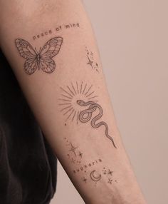 a woman with a tattoo on her arm has a butterfly and star tattoos on it