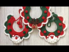 three crocheted christmas wreaths with santa claus and reindeer noses