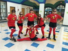 a group of people in red shirts and black pants