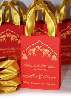 red and gold bags with golden ribbons on them