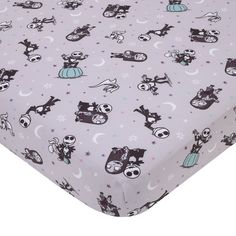 a purple sheet with black and white cartoon characters on it, all over the surface