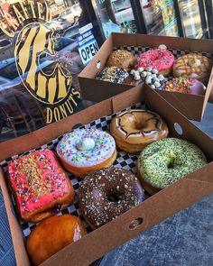 two boxes filled with different kinds of doughnuts