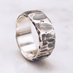 A textured Band Ring in 925 Sterling Silver with a unique raw textured and hammered finish. A stylish piece for both men and women. Available in Brass https://etsy.me/2U8LIgT Ring Size Available in all sizes. Please be sure to find your exact ring size for the finger you want before ordering. See image chart above or you can use the chart on my website as a guide - https://jewelrylab.co/pages/ring-sizing-tips Every piece is handcrafted in Bali and made with Intention, Love, and Soul so that it c