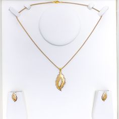 Dazzle in our Magnificent Shiny 22K Gold Pendant Set. This set, weighing 7.0 grams, features a striking combination of yellow and white gold finishes. The 1.7" pendant and matching 0.7" earrings with push back posts exude a brilliant shine. Own this 3-piece set and add a touch of glamour to your style. PRODUCT DETAILS Gold Purity(karat): 22k Gold Weight(grams): 7.0 Item Finish: Yellow + White Gold Pendant Length: 1.7" Matching Earrings: Included Earring Length: 0.7" Earring Post: Push Back Numbe Gold Pendant Set, White Gold Pendant, Earring Post, 22k Gold, Pendant Set, Matching Earrings, Gold Finish, Gold Pendant, Post Earrings