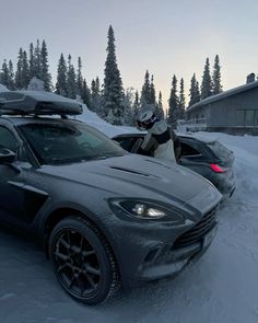 a car is parked in the snow with skis on top