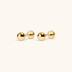 gold ball stud earrings on a white background