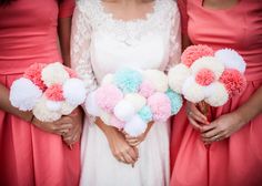 the bridesmaids are holding pom - poms in their pink and blue bouquets