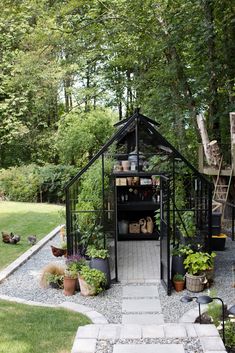 an outdoor garden with lots of potted plants