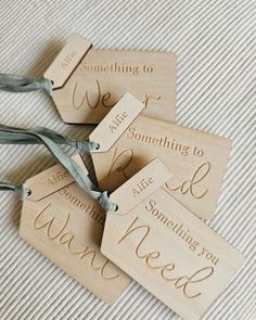 four wooden tags that say something to do and one has a string tied around it