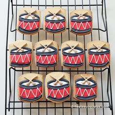 cookies decorated with musical instruments and drums on a cooling rack, ready to be eaten