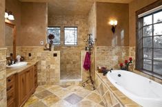 a bath room with a tub a sink and a window