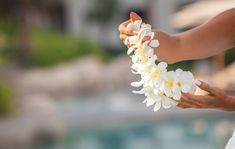 a woman holding white flowers in her hands