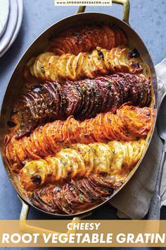 a pan filled with different types of food on top of a blue tablecloth next to silverware