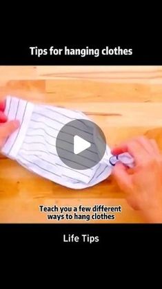 a person is wrapping clothes on top of a wooden table with text that reads tips for hanging clothes teach you a few different ways to hang clothes