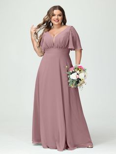 a woman in a long, dusty pink bridesmaid dress poses for the camera