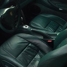 the interior of a car with green leather seats