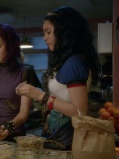 two women are preparing food in the kitchen