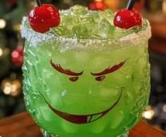 a green drink with two cherries on top