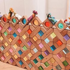 several wooden toys are arranged on top of each other in the shape of a pyramid