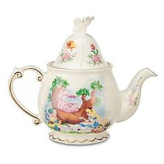 a white tea pot with disney characters on it