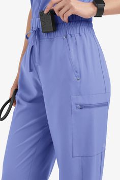 These scrub pants feature a modern fit and high waist with fashionable wide waistband with self drawcord for comfort and fit. For storage there are 5 pockets; 2 front angled pockets with shiny nickel rivet detail, 2 cargo pockets with smooth face ziper closure and 1 concealed power-mesh phone card pocket inside wearers right front pocket. Also has flattering side panels. Easy Stretch scrub collection is designed for a modern look and easy fit for very long shifts and made with performance 4-way Pants With Pockets And Adjustable Waist, Bottoms With Adjustable Waist And Side Pockets, Comfort Stretch Tapered Leg Bottoms With Pockets, Bottoms With Side Pockets And Adjustable Waist, Blue High Waist Comfort Stretch Pants, Versatile Blue Pants With Pockets, High Waist Blue Pants With Comfort Stretch, Mid-rise Comfort Stretch Pants With Pockets, Comfort Stretch Mid-rise Pants With Pockets