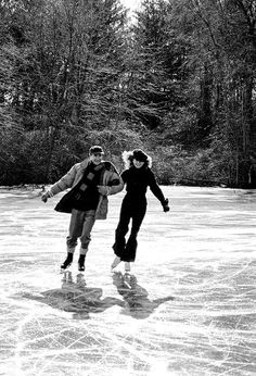 two people are skating on an ice rink