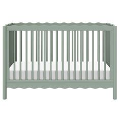 a green crib with white sheets on the bottom and side rails, in front of a