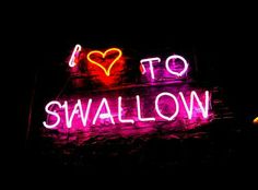 i love to swallow neon sign in the dark