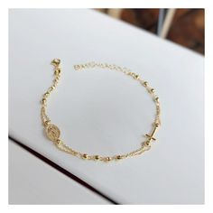 This beautiful rosary bracelet is made of gold plated silver, with cross and Miraculous Medal.  This beautiful elegant bracelet is an ideal gift for Catholic women on all occasions.  If you want to have a bracelet with a deeper meaning, this one is ideal for you Due to its simplicity, it can be worn every day and is easily combined with other jewelry. Lenght of bracelet is 17, 5 plus 4 cm.  Diametar of beads: 3 mm Weight: 3,10 gr For any religious occasions. If you want to see the rest of our se Dainty Rosary Bracelet Gift With Round Beads, Dainty Rosary Bracelet Gift, Spiritual Rosary Bracelet With Adjustable Chain, Dainty Rose Gold Rosary Bracelet Gift, Dainty Rose Gold Rosary Bracelet, Gold Cross Beaded Bracelets For Gift, Gold Cross-shaped Beaded Bracelets For Gifts, Elegant Cross Beaded Bracelets As Gift, Gold Dainty Rosary Bracelet