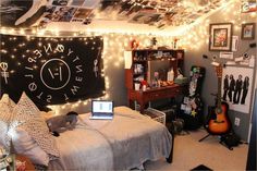 a dorm room decorated with lights and pictures on the wall, bed in foreground