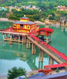 a red and yellow building sitting on top of a pier