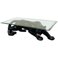 a glass coffee table with a black cat design on the top and bottom, sitting in front of a white background