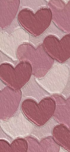 pink and white hearts are arranged in the shape of heart shapes on a textured paper background