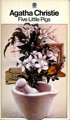 a white vase filled with flowers on top of a table