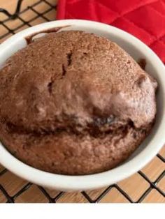 a close up of a bowl of food on a cooling rack with a red cloth