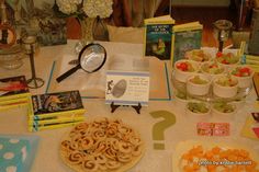 a table topped with lots of food and books