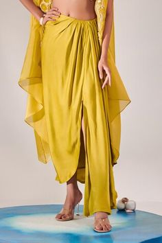 Yellow asymmetric cape with zardozi sequin embroidered floral patterns on border. Comes with padded sequin embroidered blouse and draped skirt. - Aza Fashions Draped Kaftan For Wedding, Designer Cape Dress, Asymmetric Cape, Organza Cape, Sequin Cape, Women Kurta, Draped Skirt, Cape Sleeves, Set Women