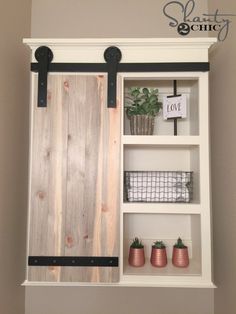 a white shelf with some plants and other things on it's shelves next to a wall