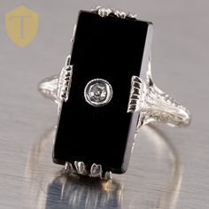 This onyx ring is absolutely beautiful Karat / Weight: 14KWG / 2.9g Size: US 5.5 Measurement: 19.3mm x 5.6mm Stone: Onyx - 1 / Diamond - 1 (0.02cttw) Markings: 14k Condition: Great Era: Vintage DELIVERY: Our shipping and handling is always fast & free unless otherwise stated. Once an order is placed and payment is received, all items are shipped within one business day, excluding weekends. For international shipments, we use Etsy's International Shipping Program. RETURNS: We are flexible and wil Classic Black Onyx Diamond Ring, White Gold Onyx Ring For Anniversary, Art Deco Onyx Ring With Black Enamel, Art Deco Onyx Jewelry For Anniversary, Black Art Deco Gemstone Jewelry, Black Onyx Diamond Ring For Anniversary, Art Deco Black Diamond Ring For Anniversary, Anniversary Onyx Diamond Ring With Polished Finish, Black Art Deco Diamond Ring For Anniversary