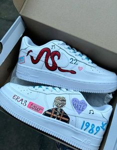 a pair of white sneakers with cartoon characters painted on them