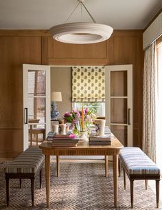 a dining room with wooden paneling and chairs