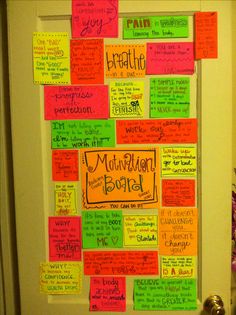 a bulletin board covered in notes and writing